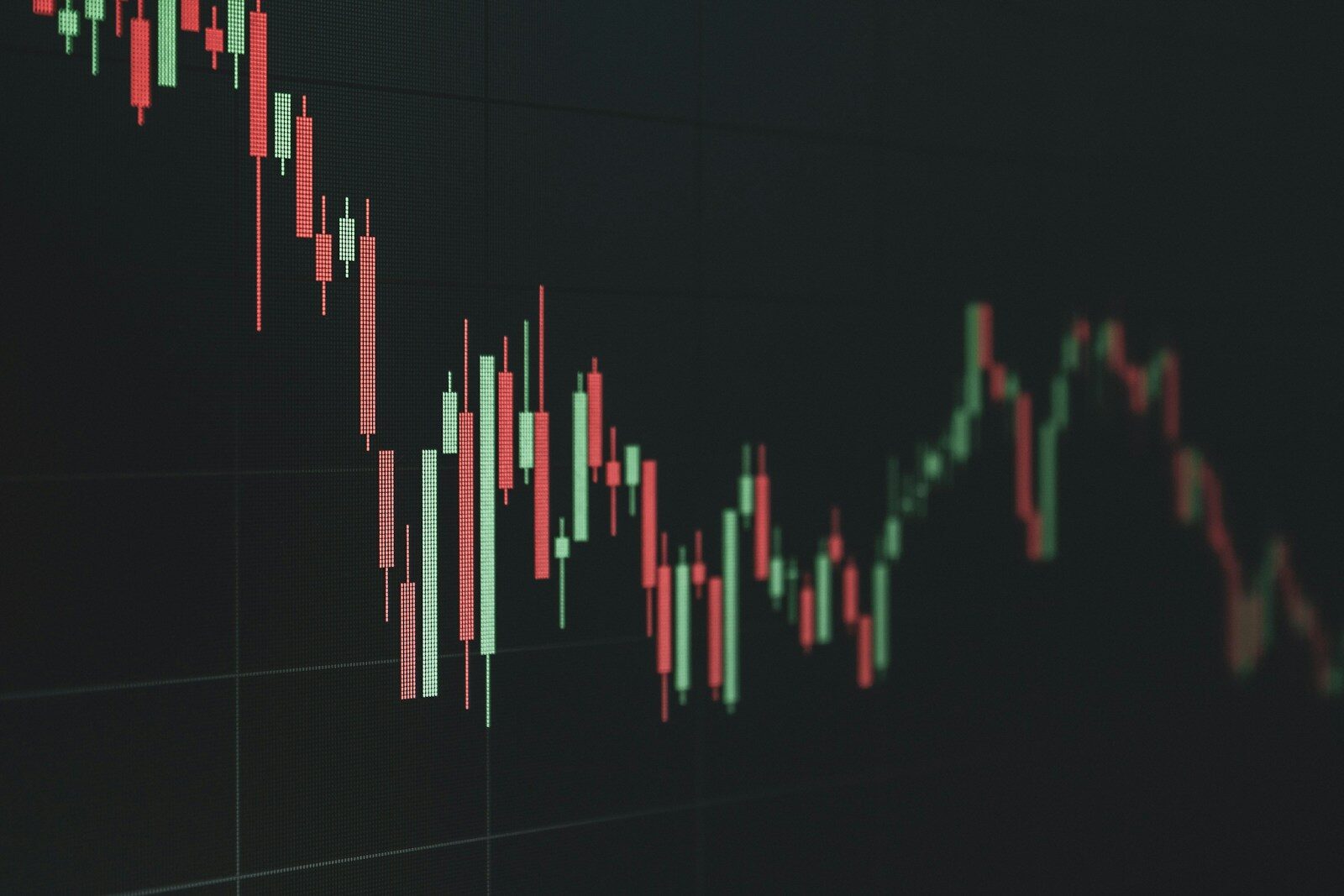 A dark background candlestick chart showing fluctuating financial market trends.